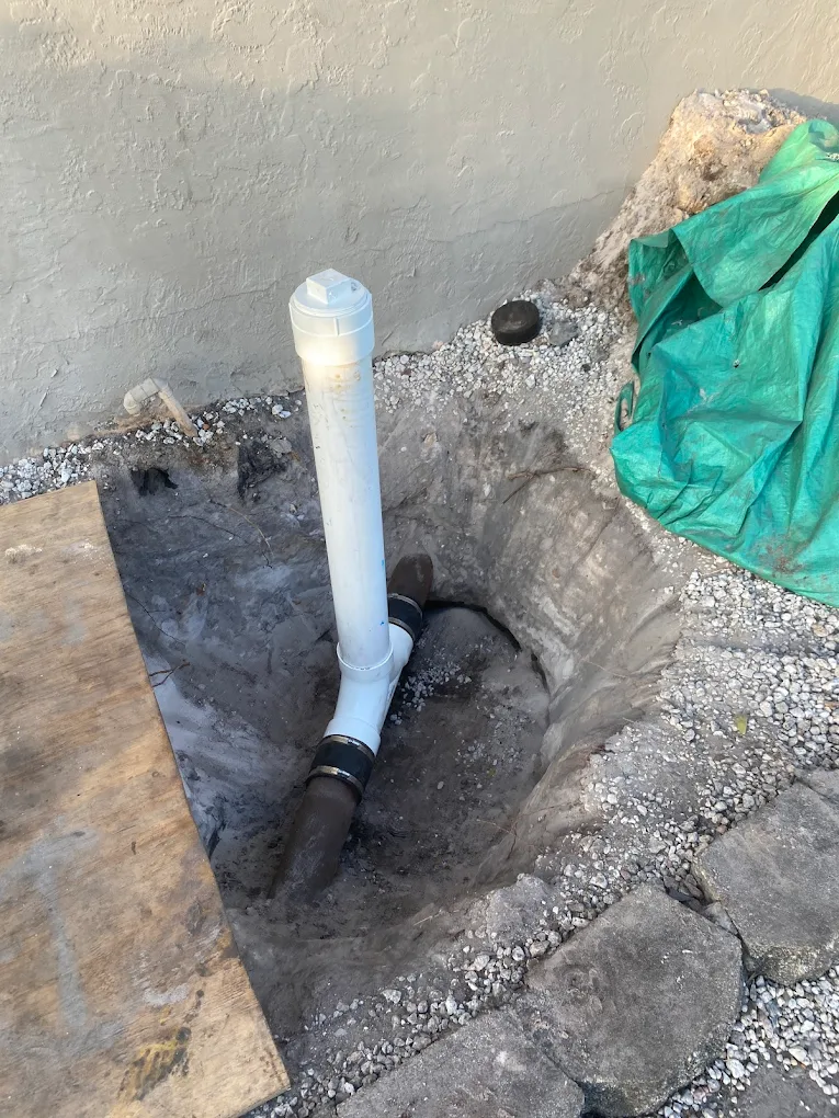 Plumber working on pipe